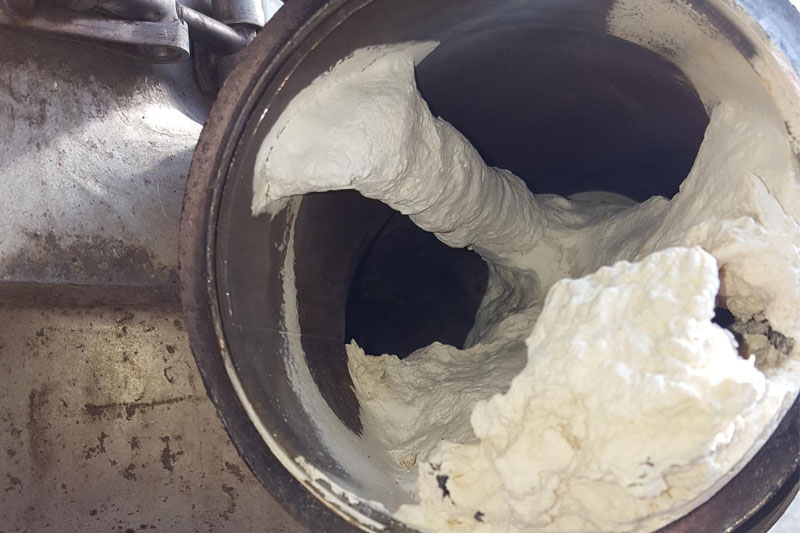 Severe white AdBlue crystal deposits obstructing the inside of metal exhaust pipework